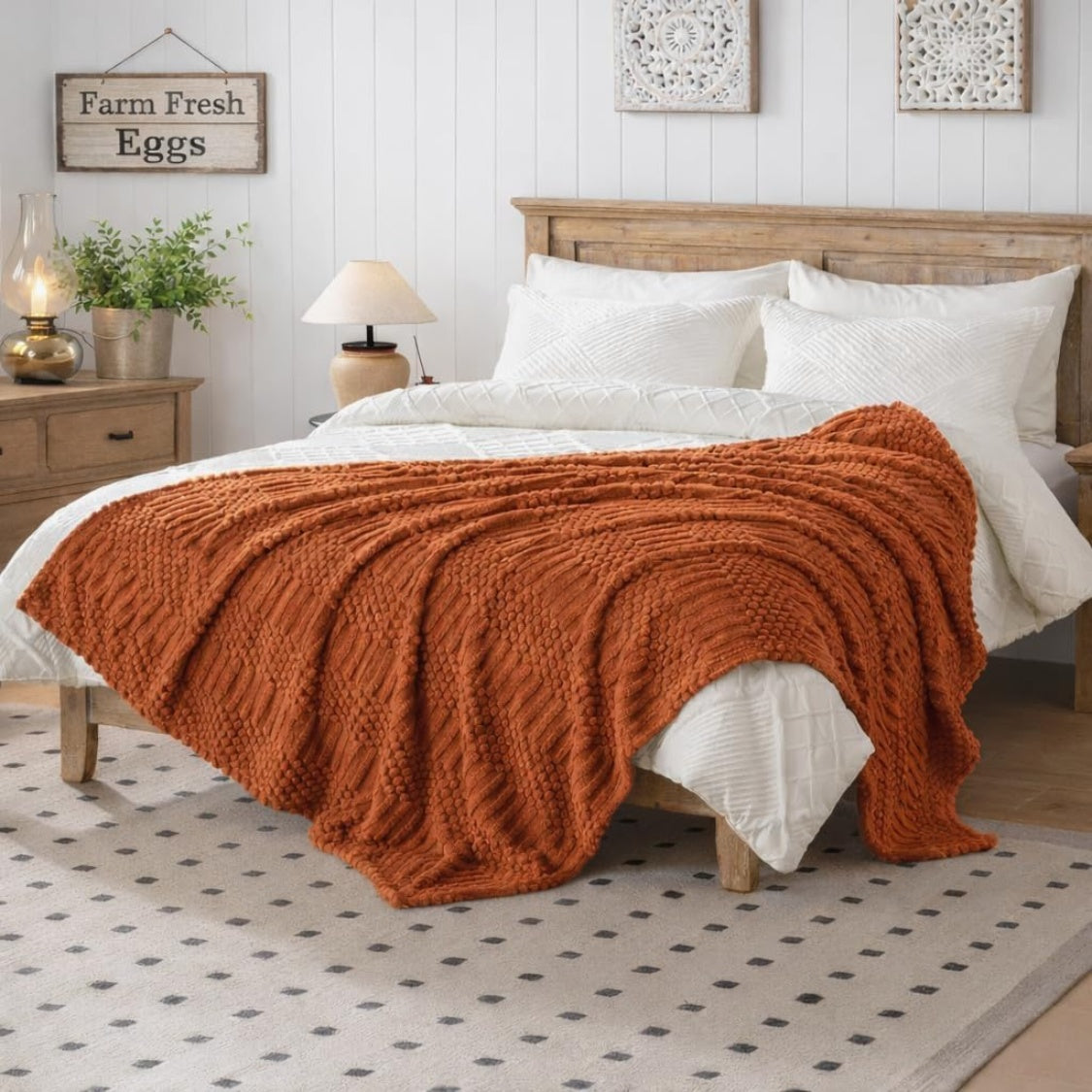 Rust colored fleece throw blanket folded on a sofa, view 3