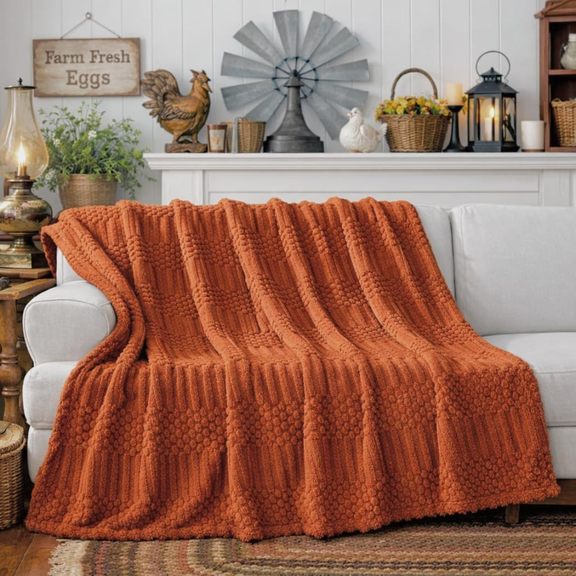 Rust colored fleece throw blanket folded on a sofa, view 2