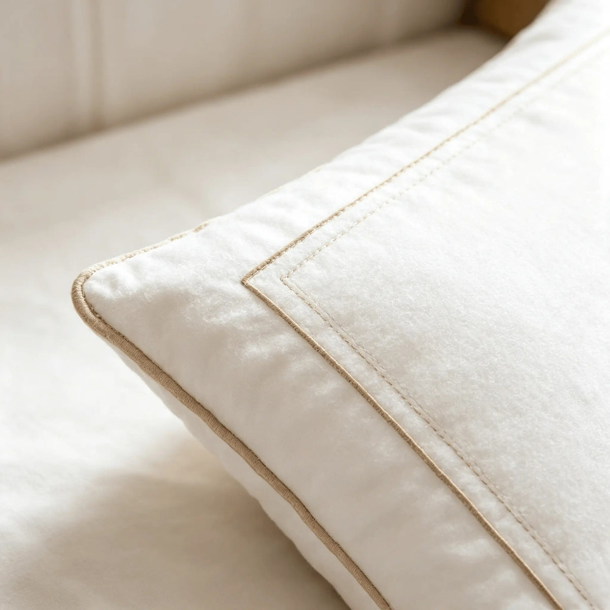 Close-up of the double-stitched border on a white hotel pillow
