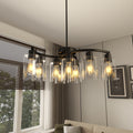 Nine-light black chandelier with clear glass shades over a dining table