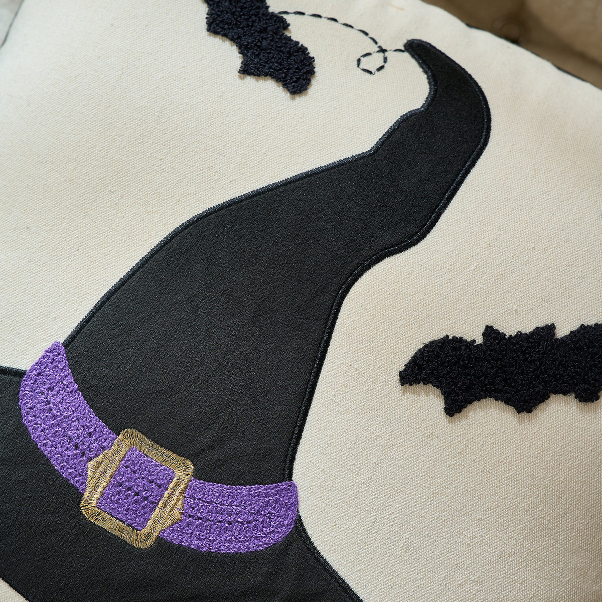 Close-up of the tufted black witch hat and bat cushion detail