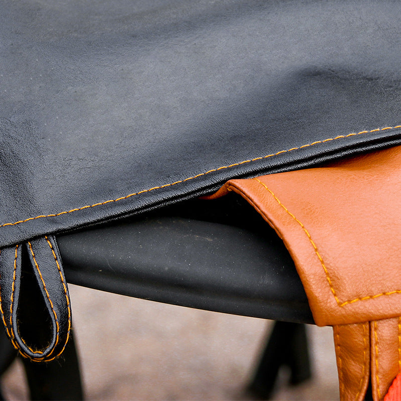 Close-up of the black leather surface and contrasting tan reverse side