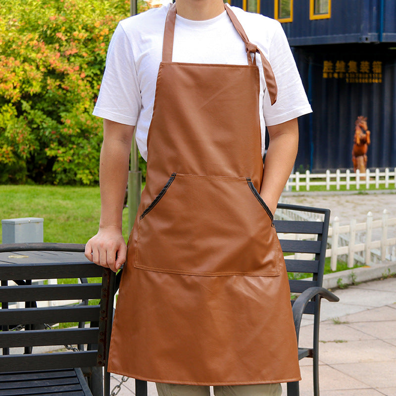 Man wearing a tan leather work apron outdoors in a workshop yard