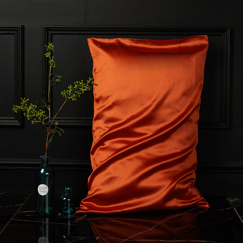 Vivid orange mulberry silk envelope pillowcase adding warm colour to dark styling