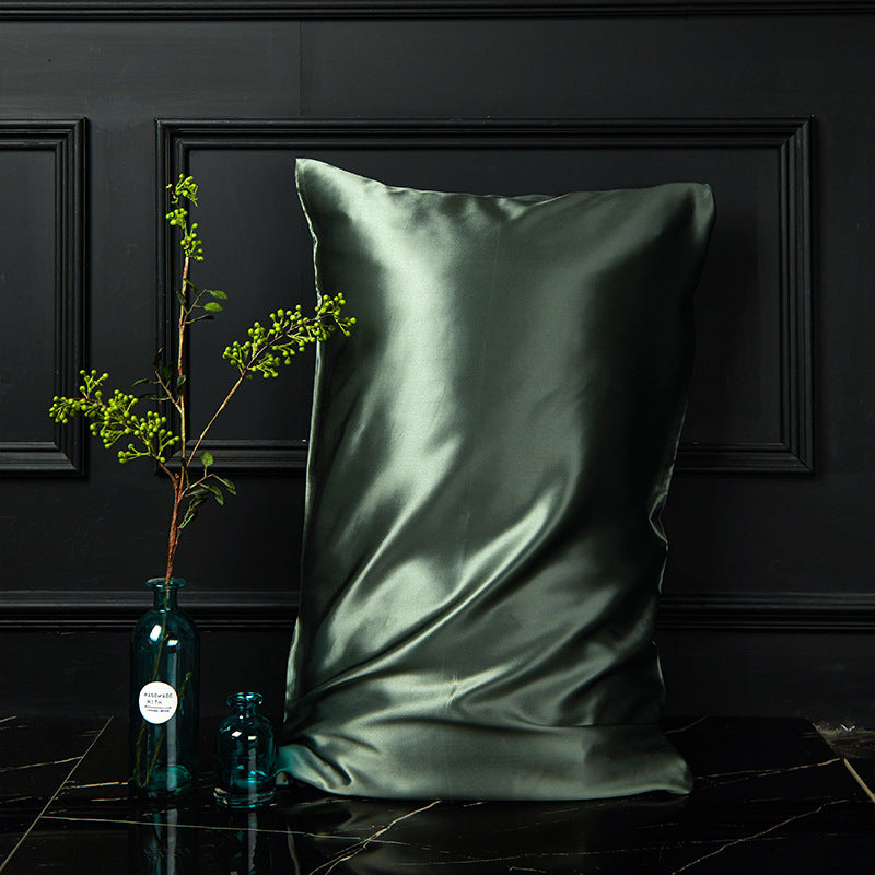 Olive green mulberry silk envelope pillowcase styled with greenery on dark marble