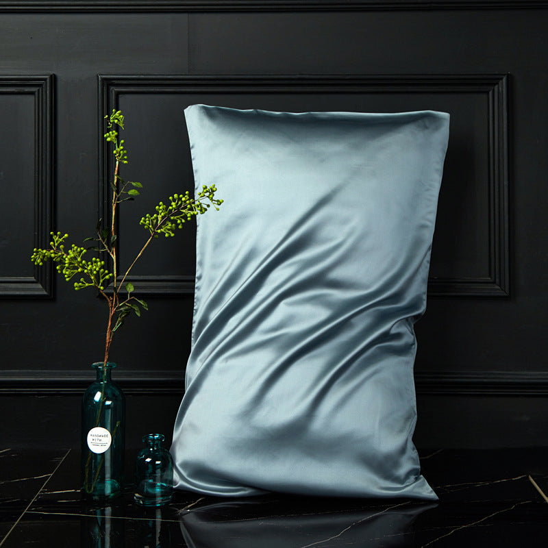 Pale twilight blue mulberry silk envelope pillowcase styled in a dark bedroom