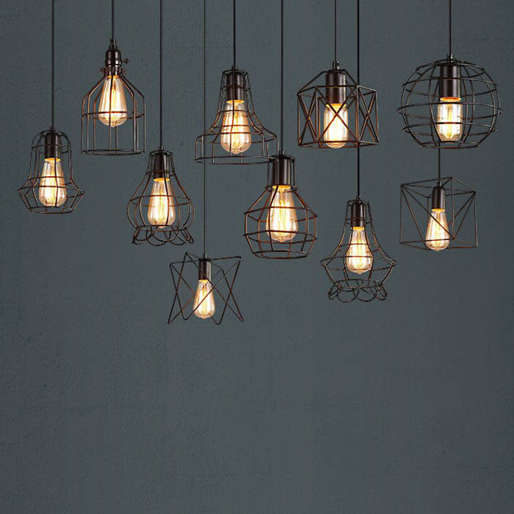 Cluster of Nordic cage pendant lights with warm Edison bulbs