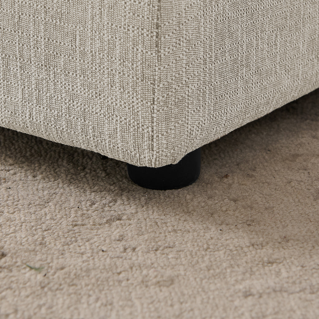 Close-up of the low plastic foot beneath the linen pet sofa