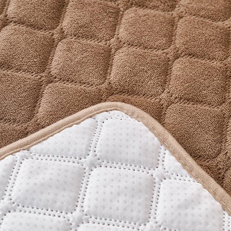Corner folded back to show the quilted bed's contrasting pale underside
