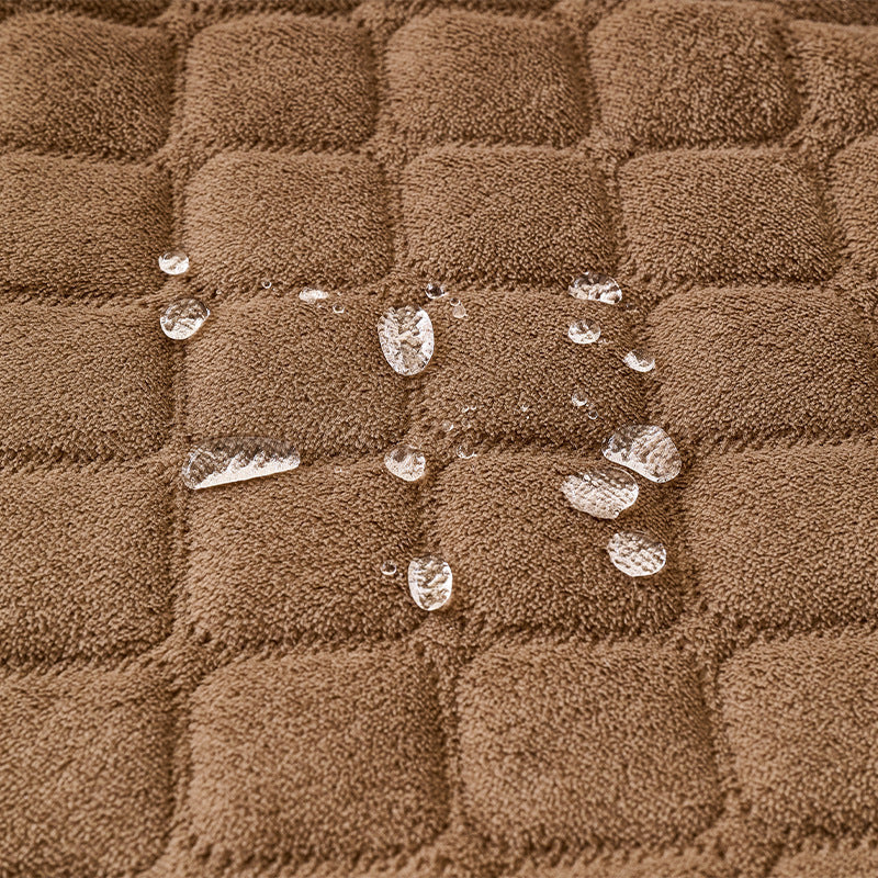 Water droplets beading on the quilted surface of the pet bed